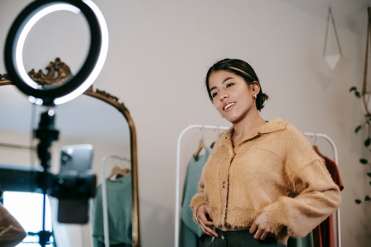 A creator presenting an outfit to her phone camera